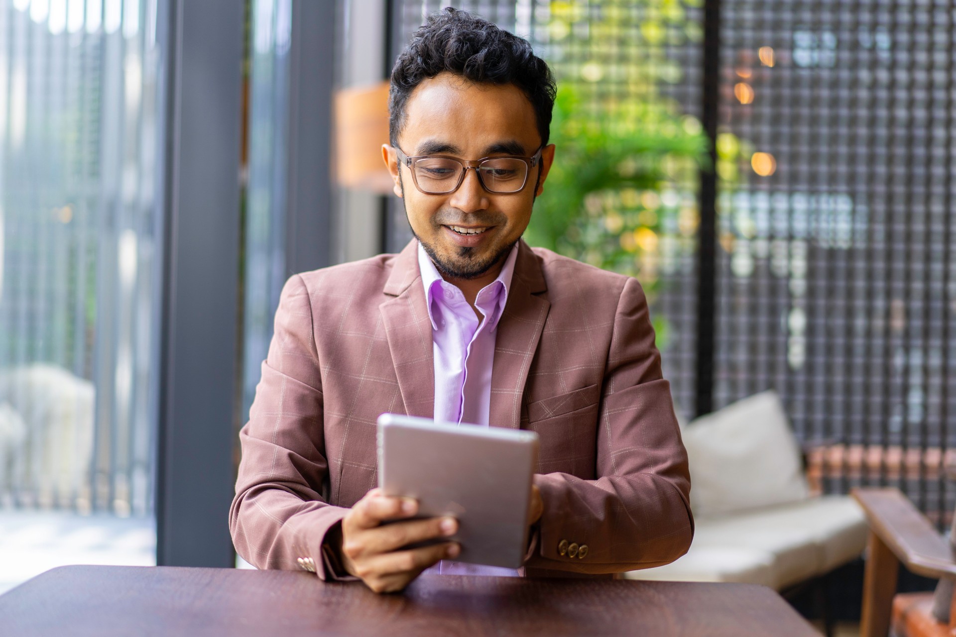 Asian Malay businessman working with digital tablet.